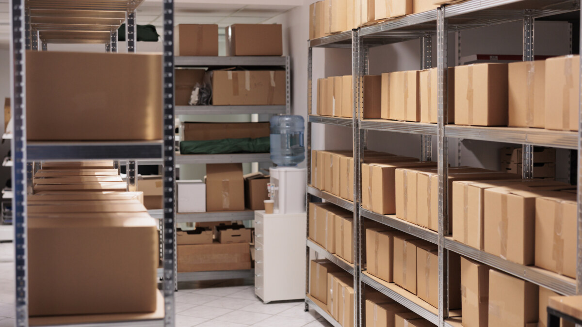Cardboard boxes stacked on racks inside a secure self storage unit at Royal Phuket Marina